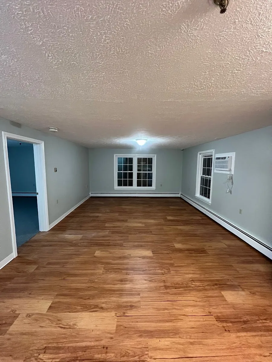Freshly painted interior room with soft blue-grey walls and white trim.
